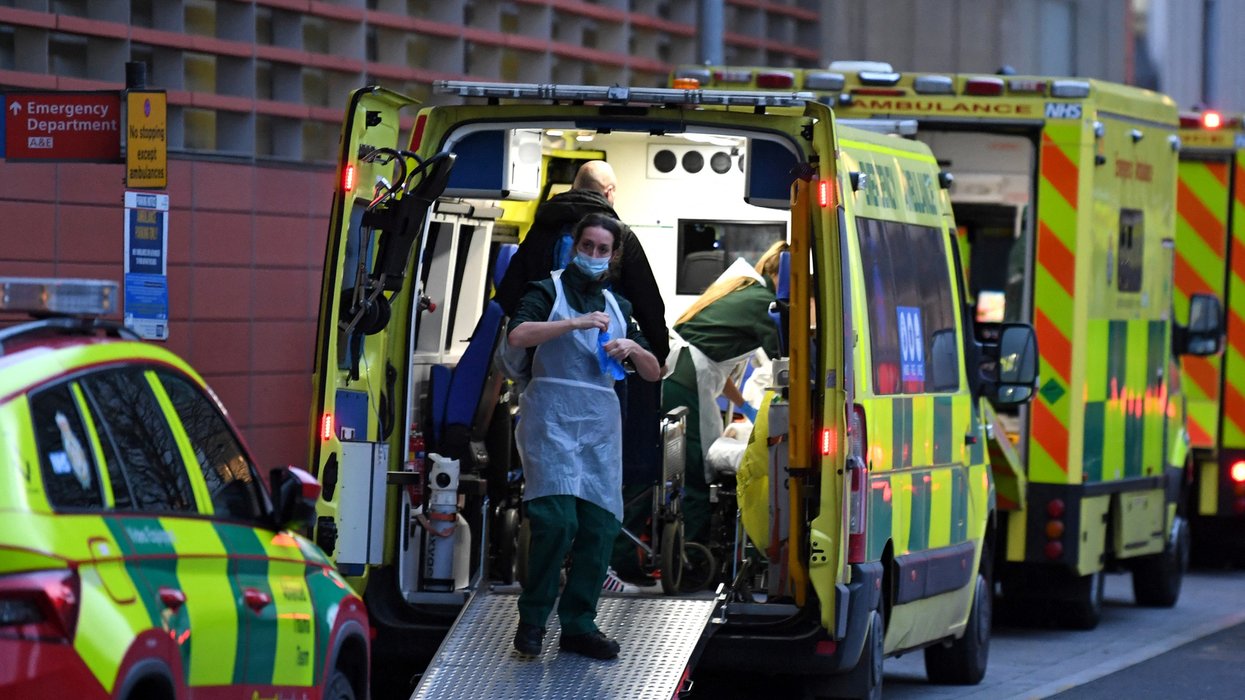 Paramedics work inside an ambulance parked outside the Royal London Hospital