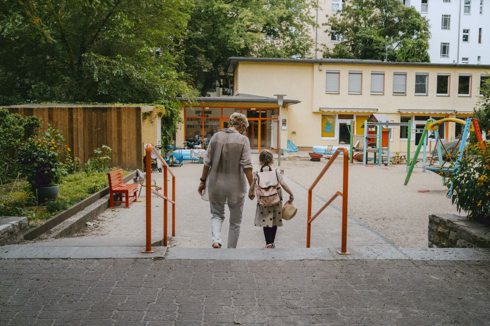 Parent taking a child to nursery/school