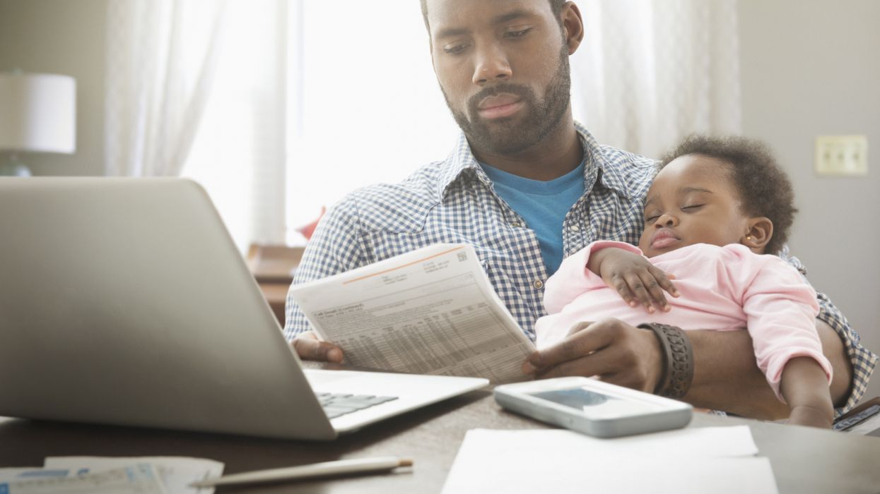 Parent with child looking at letter