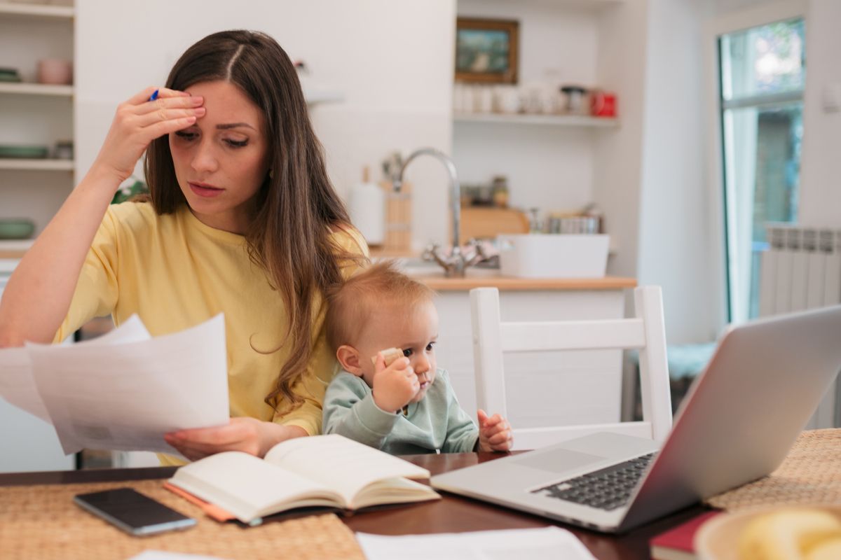Parent with child looks at letter