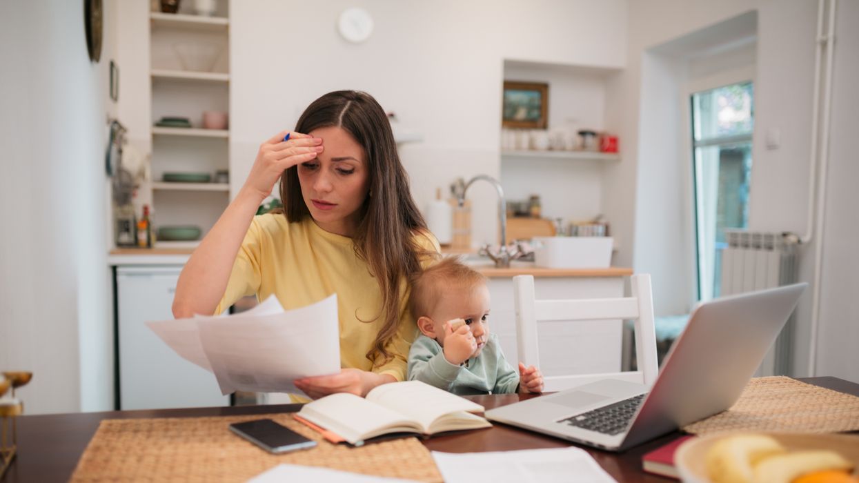 Parent with child looks at letter