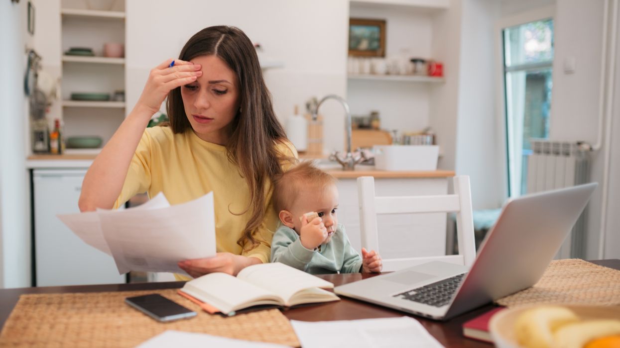 Parent with child looks at letter