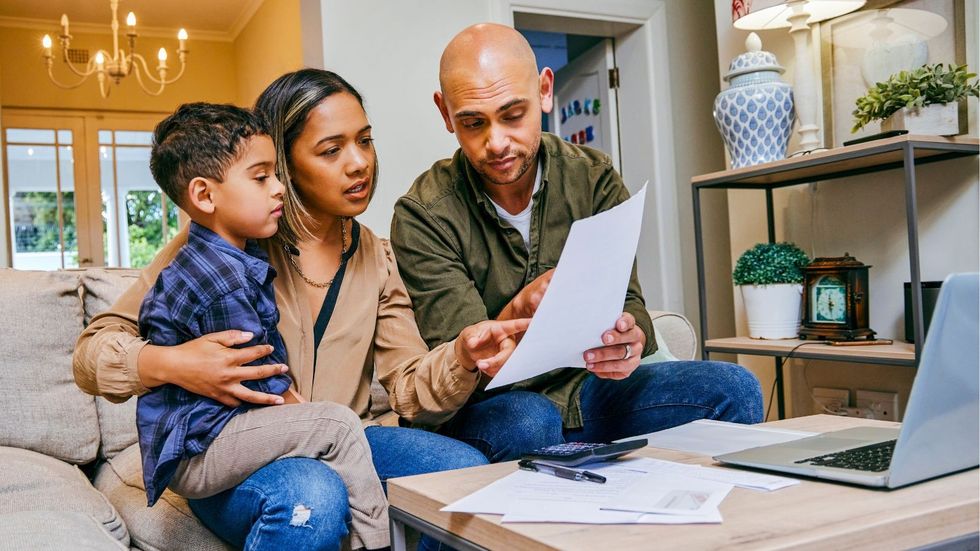 Parents and child look at finances