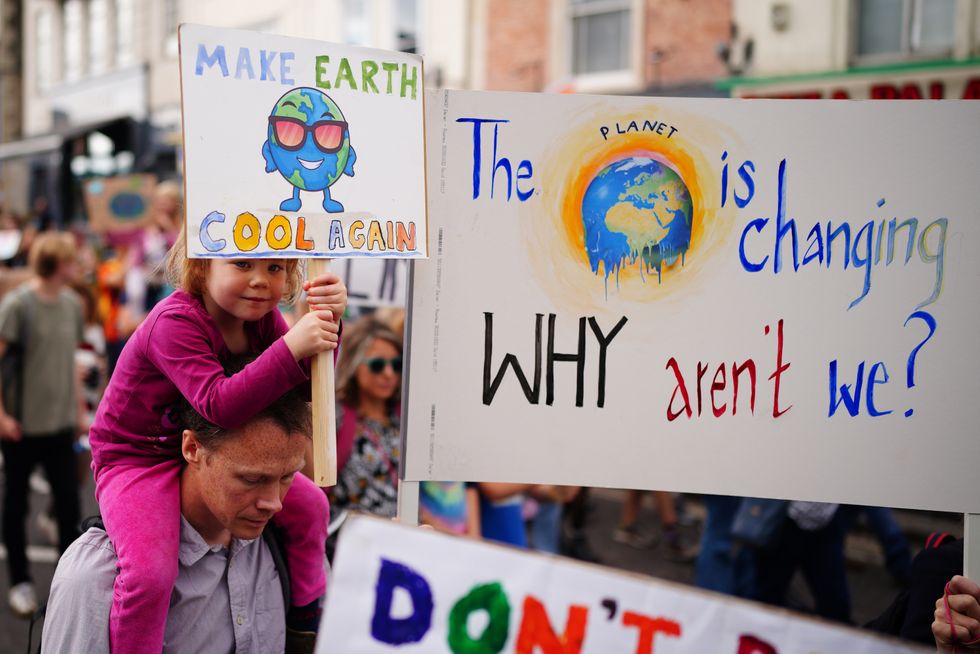 Parents and children taking part in a global youth climate strike. Eco-conscious pupils, parents and teachers are demanding more action on the climate crisis during the festive season.