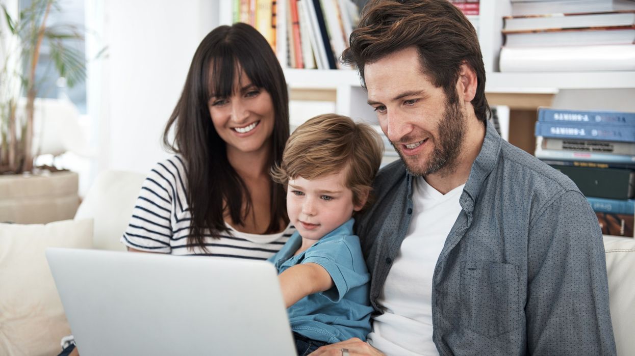 Parents and their child looking at laptop