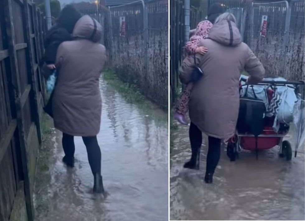 Parents have been filmed struggling to wade through the flooded area