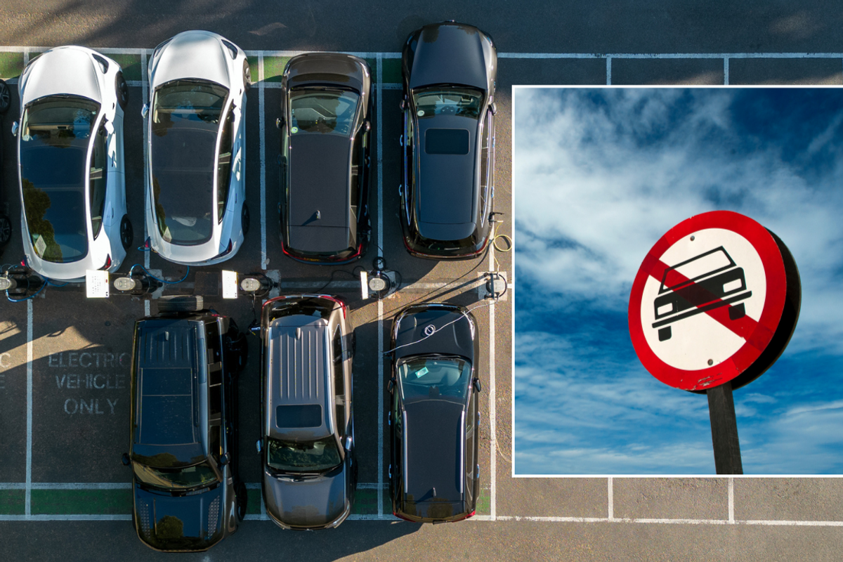 Parked car and car ban sign