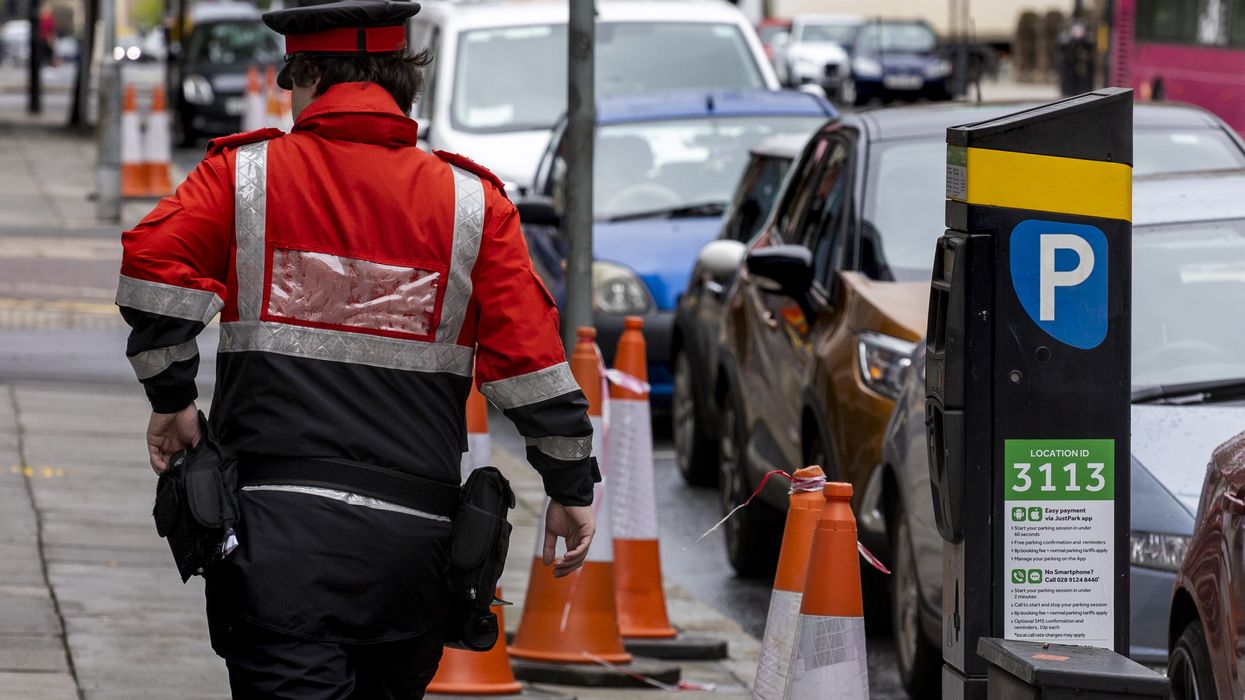 Parking inspector walking past a pay and display