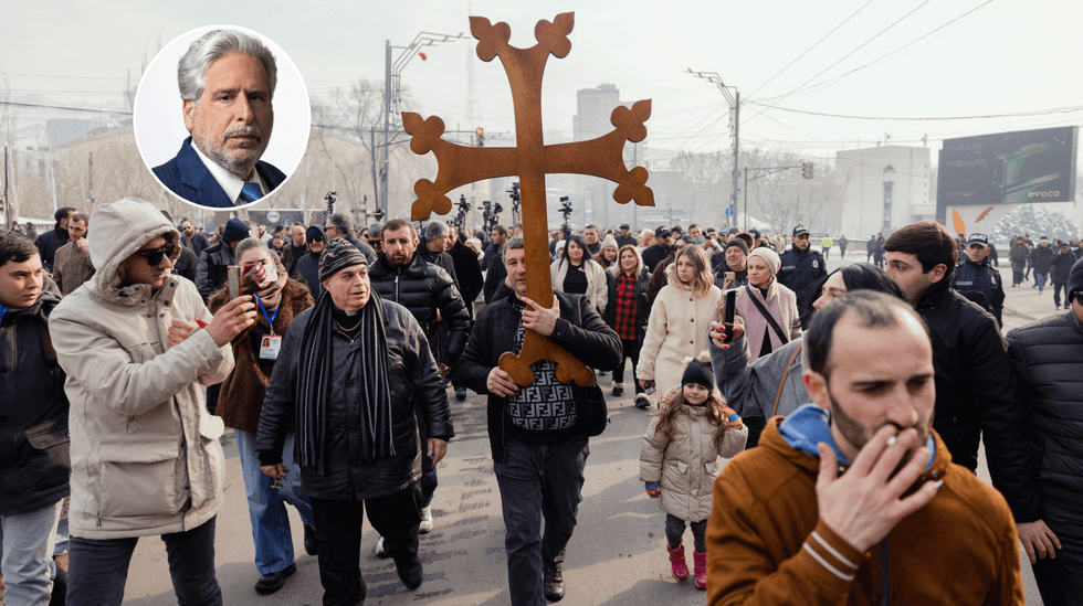 Participants carry a wooden cross as they walk during a march in Yerevan, Armenia on January 6, 2026. The march took place as Armenia marked Christmas and followed a religious service attended earlier by the prime minister, amid tensions between the government and the Armenian Apostolic Church