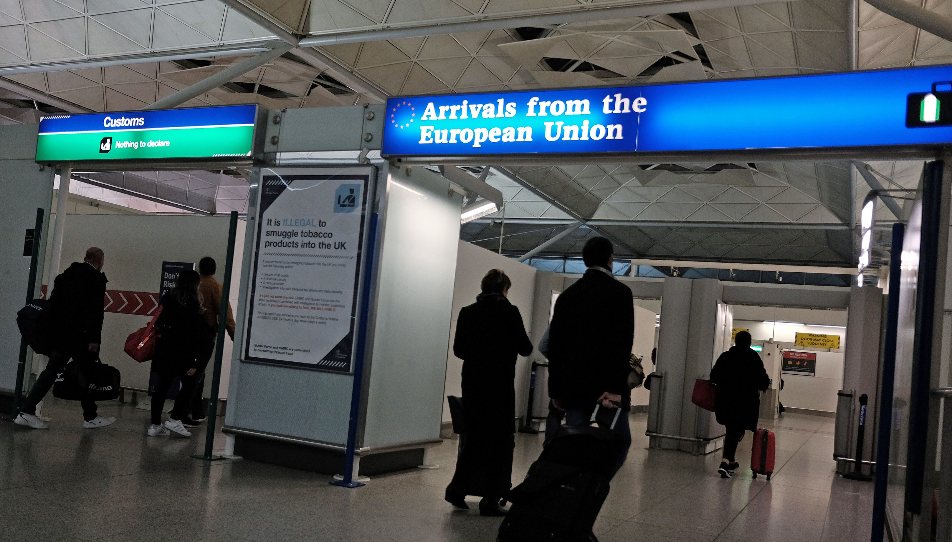 Passengers arriving back to the UK pass through customs and immigration at Stansted airport, London.
