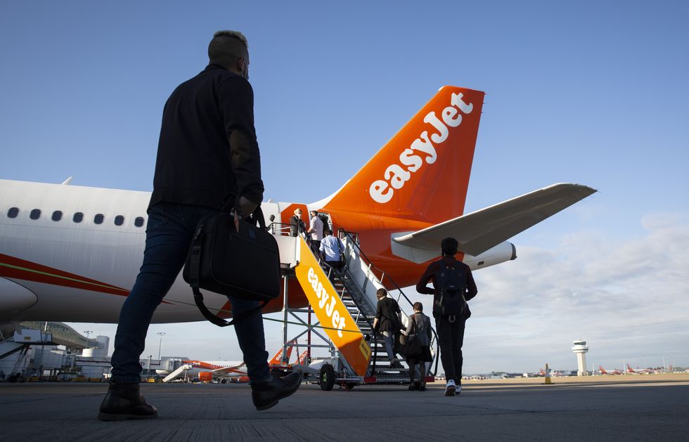 Passengers board easyJet flight EZY883 before it takes-off from London Gatwick