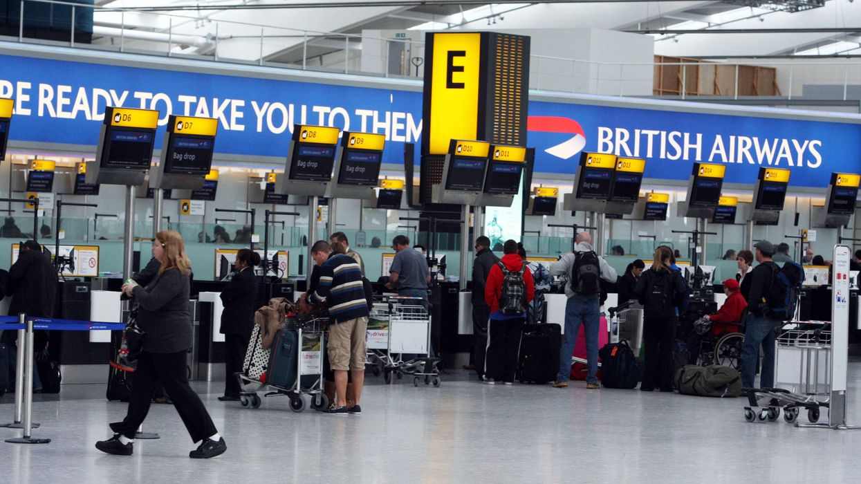 Passengers check in at Terminal 5 of Heathrow Airport in Middlesex, as British Airways cabin staff continue a third day of strike action