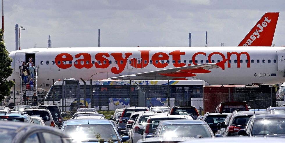 Passengers dis-embark an Easyjet plane at Liverpool John Lennon Airport,