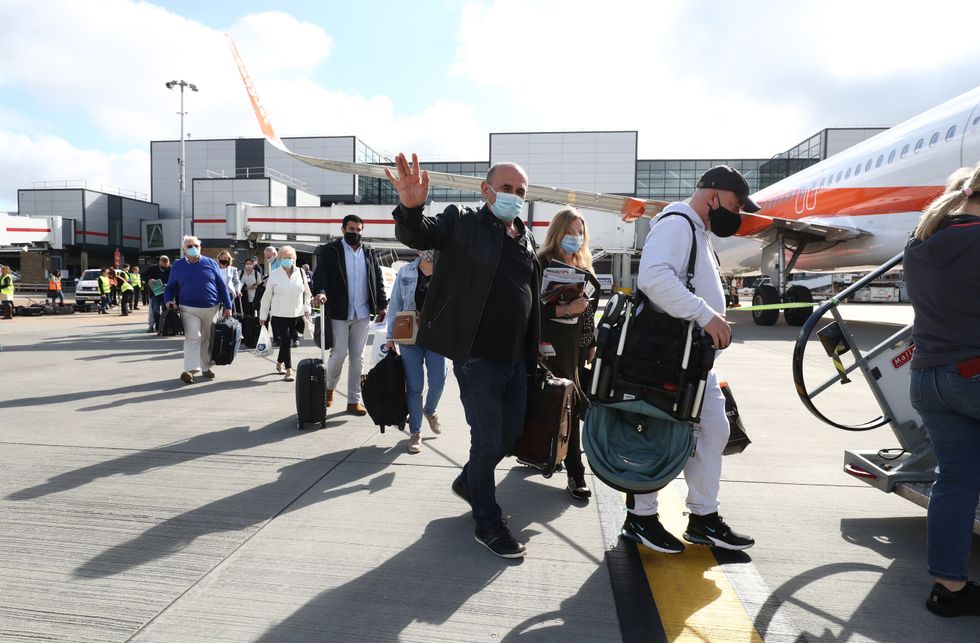 Passengers prepare to board an easyJet flight to Faro, Portugal, at Gatwick Airport in West Sussex after the ban on international leisure travel for people in England was lifted following the further easing of lockdown restrictions. Picture date: Monday May 17, 2021.