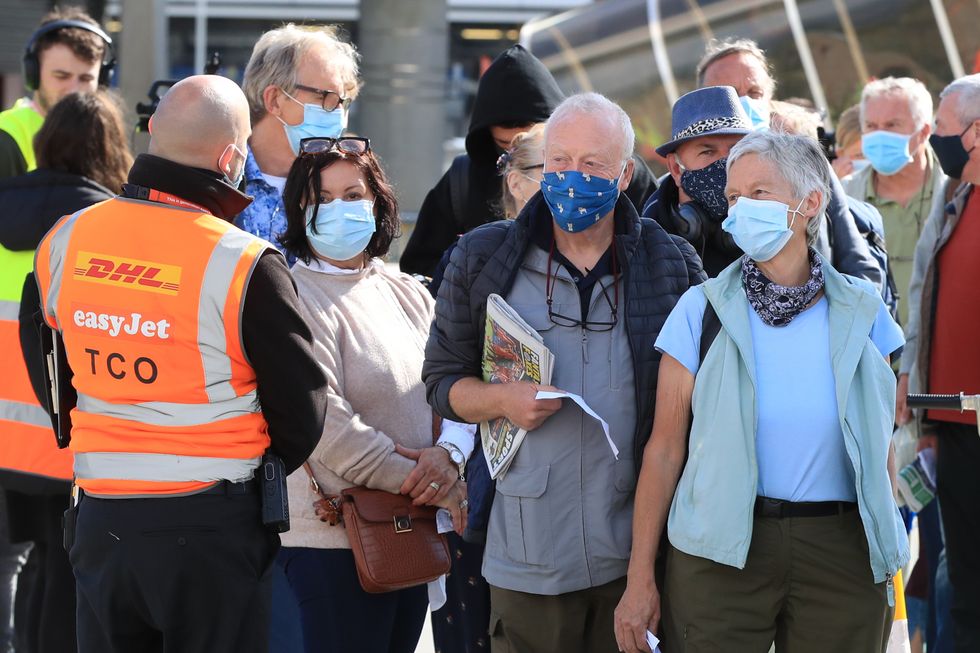 Passengers prepare to board an easyJet flight to Faro, Portugal, at Gatwick Airport