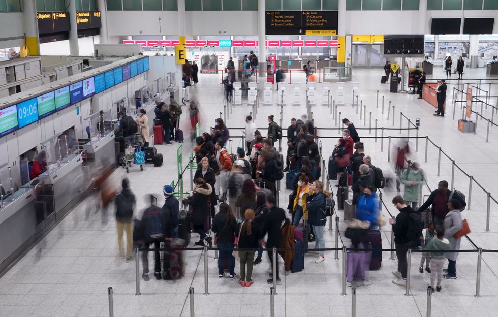 Passengers queue at an airport