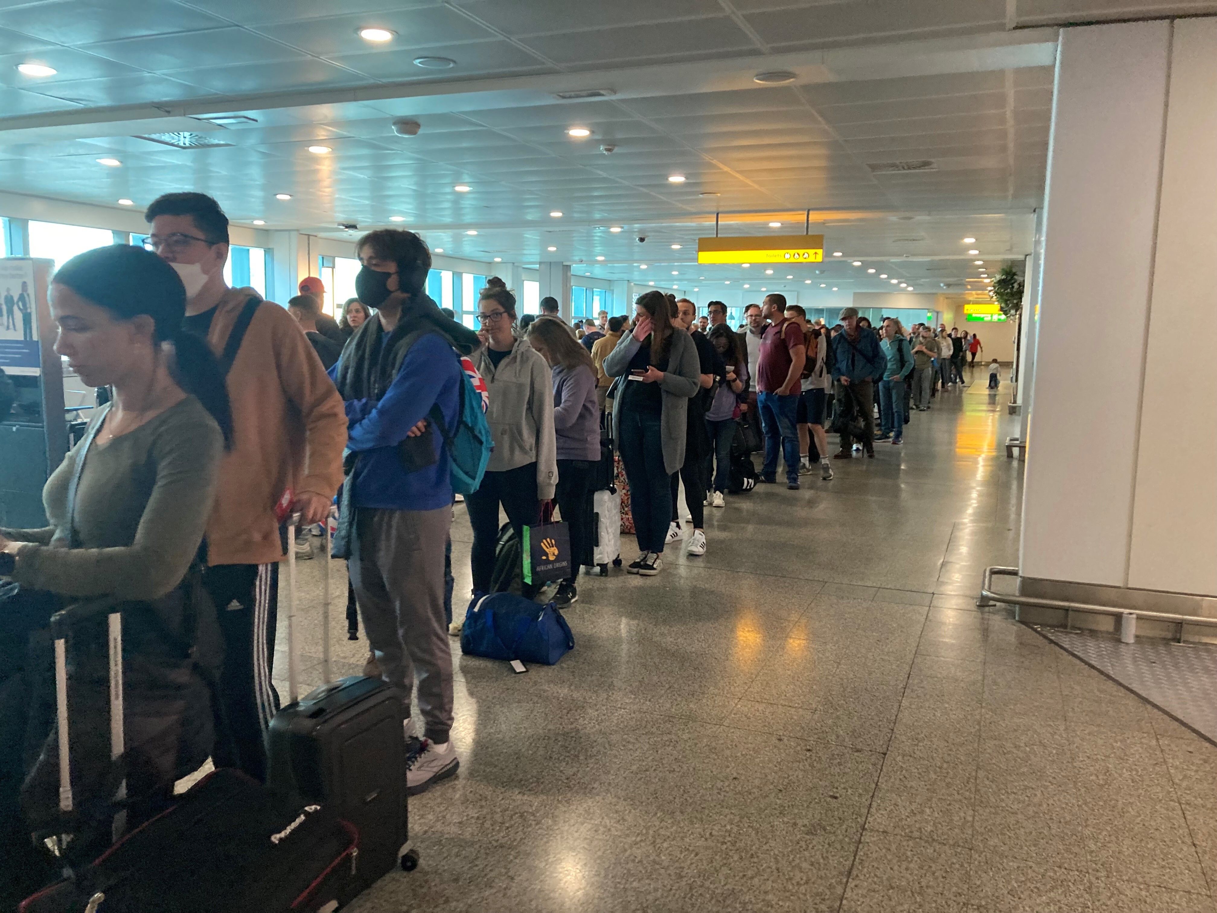 Passengers queue for flights at Heathrow Airport