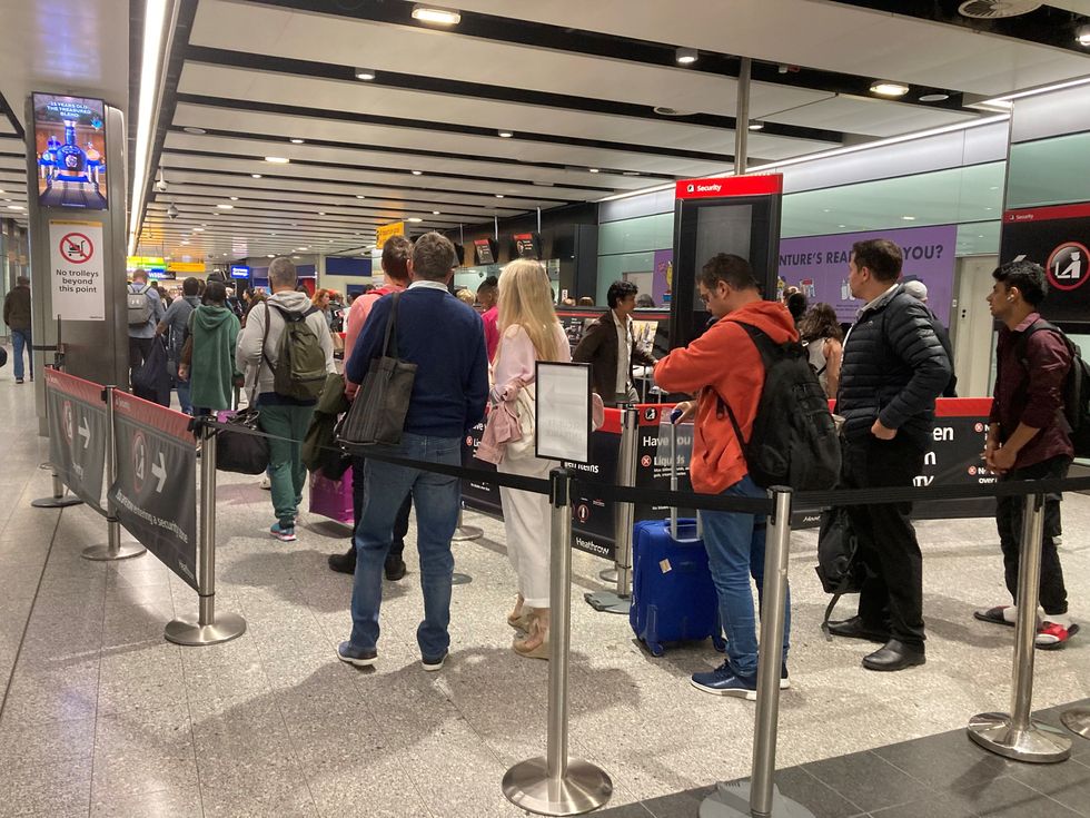 Passengers queue for flights at Heathrow Airport