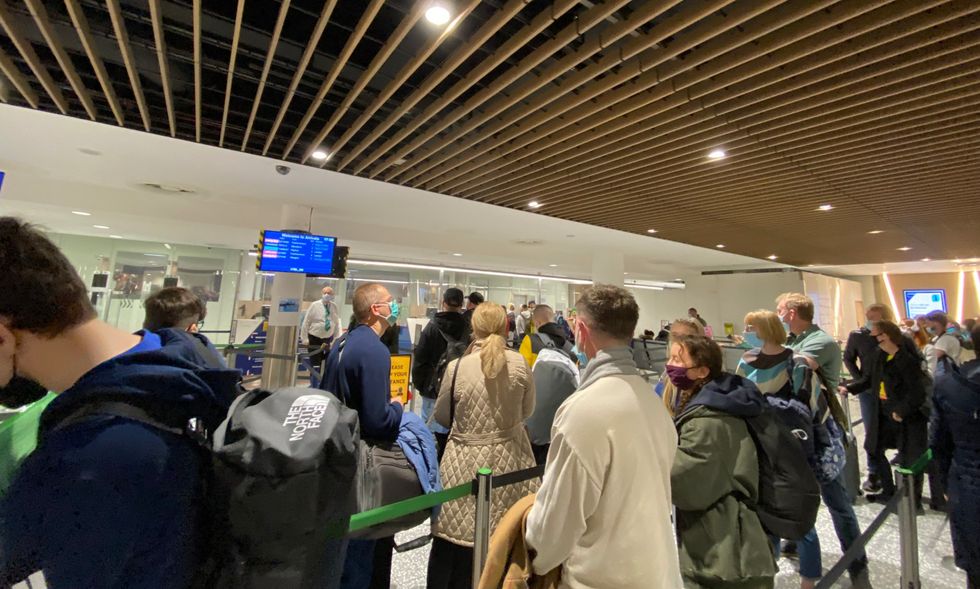 Passengers queue in Bristol Airport.