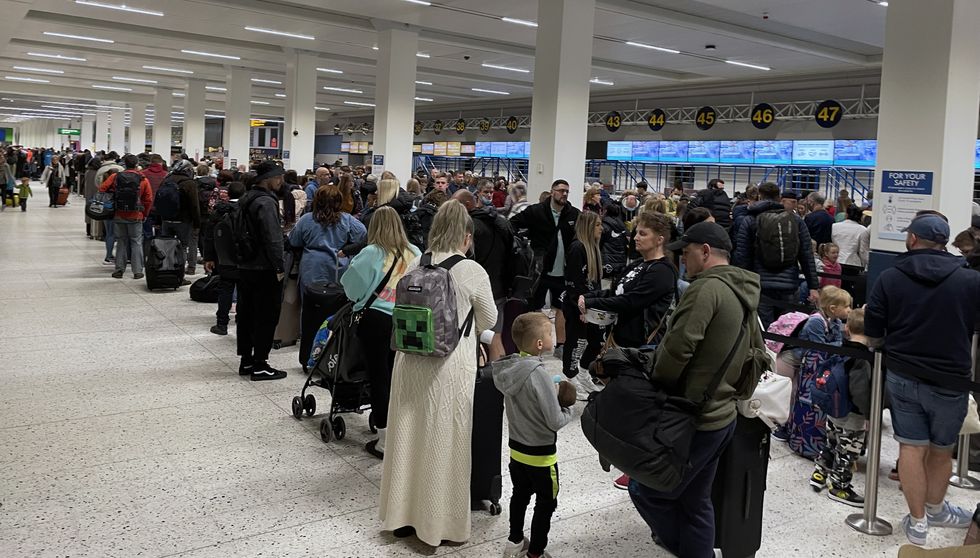 Passengers queue inside the departures area of Terminal 1 at Manchester Airport, as the getaway starts in earnest as schools close for Easter. Picture date: Saturday April 9, 2022.