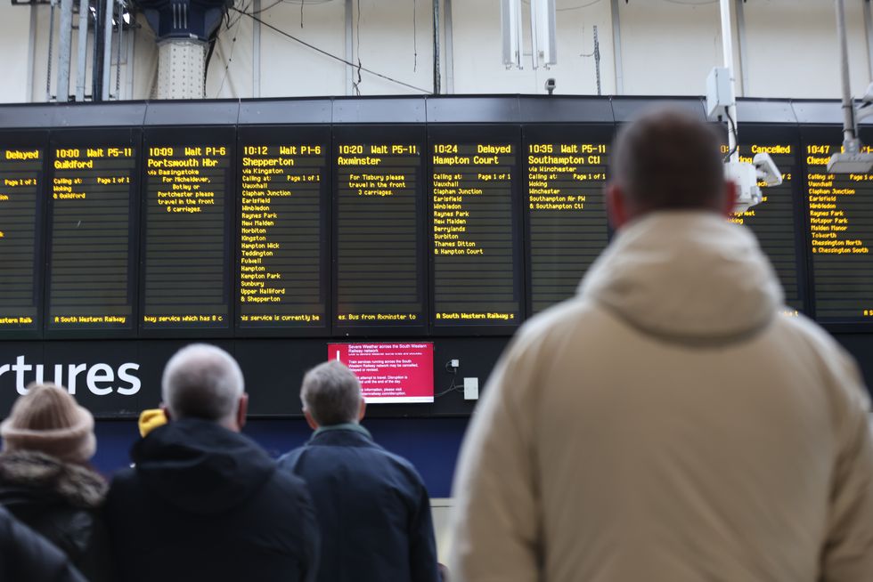 Passengers wait at Waterloo station, London, for cancelled or delayed trains in the aftermath of Storm Eunice. Picture date: Friday February 18, 2022.