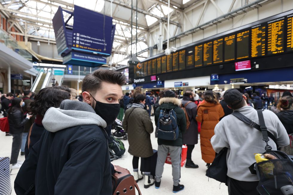 Passengers wait at Waterloo station, London.