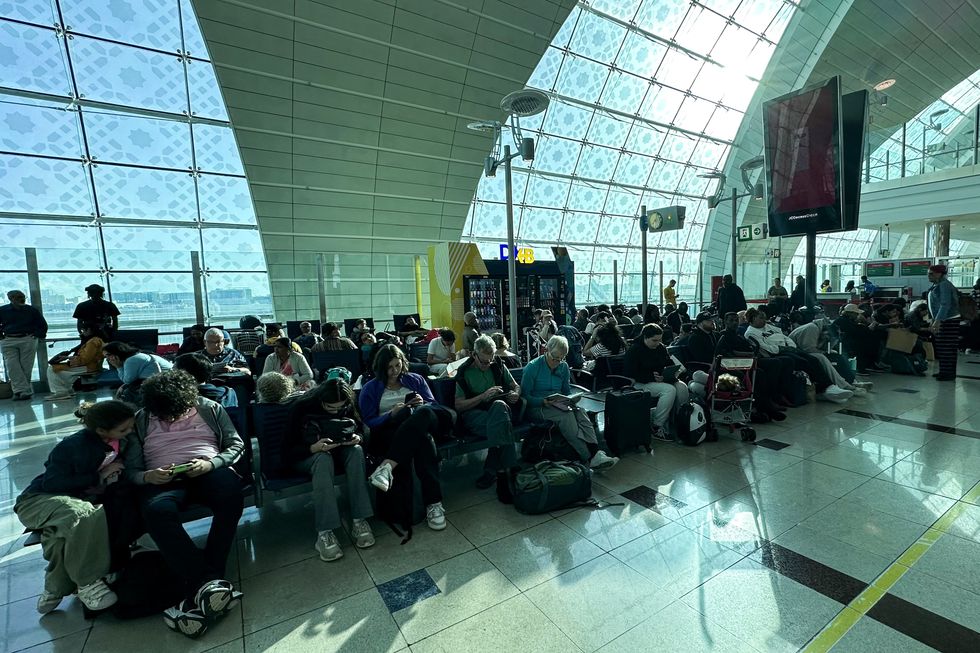 Passengers wait for their flights at the Dubai International Airport in Dubai