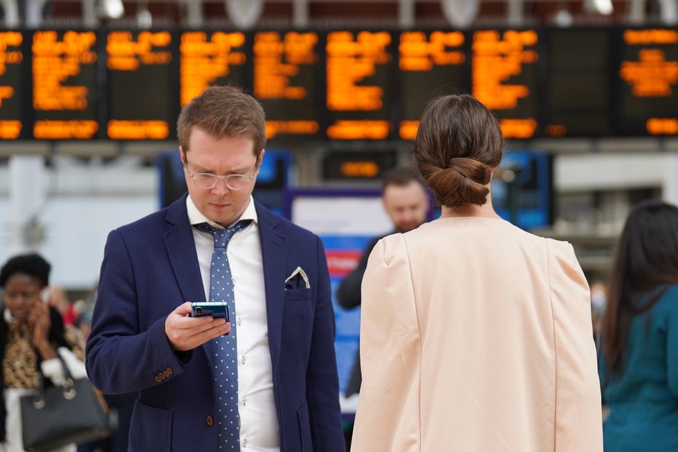 Passengers wait on the concourse at Paddington train station in London during a 24-hour strike by four transportation trade unions. Members of the Rail, Maritime and Transport union (RMT), Aslef, Unite and the Transport Salaried Staffs' Association (TSSA) have walked out across the UK with just 11 percent of services expected to run. Picture date: Saturday October 1, 2022.