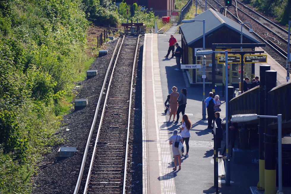 Passengers wait to board a train at Hunts Cross Station, Liverpool. MerseyRail has announced all trains will stop tomorrow due to industrial action. Picture date: Monday June 20, 2022.
