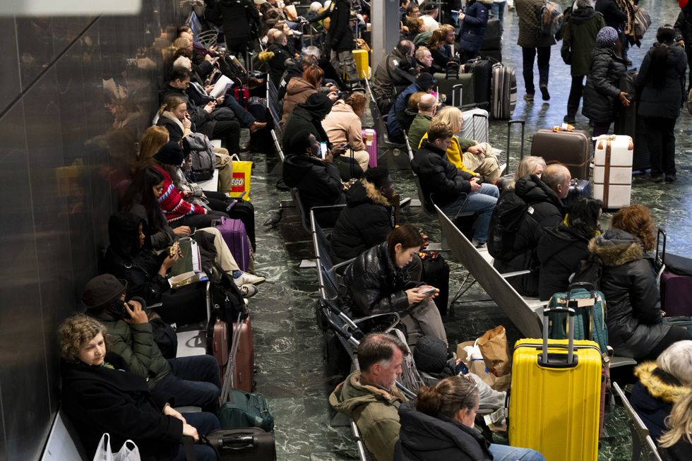 Passengers waiting at London's Euston station