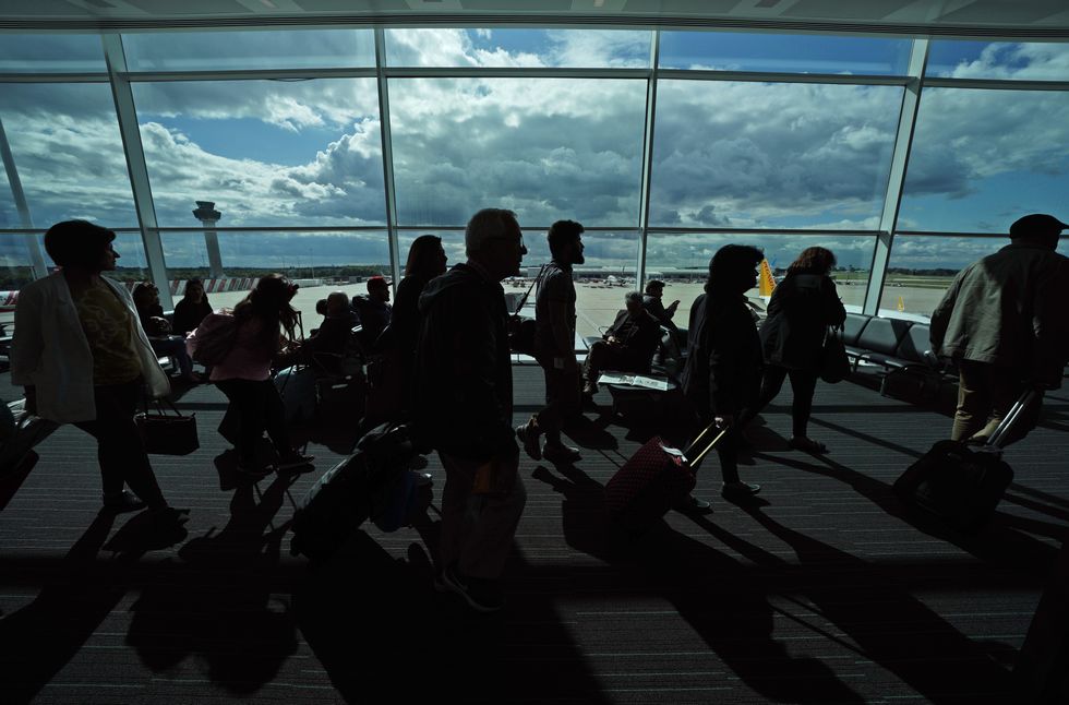 Passengers waiting in a departure lounge at London Stansted Airport, in Essex