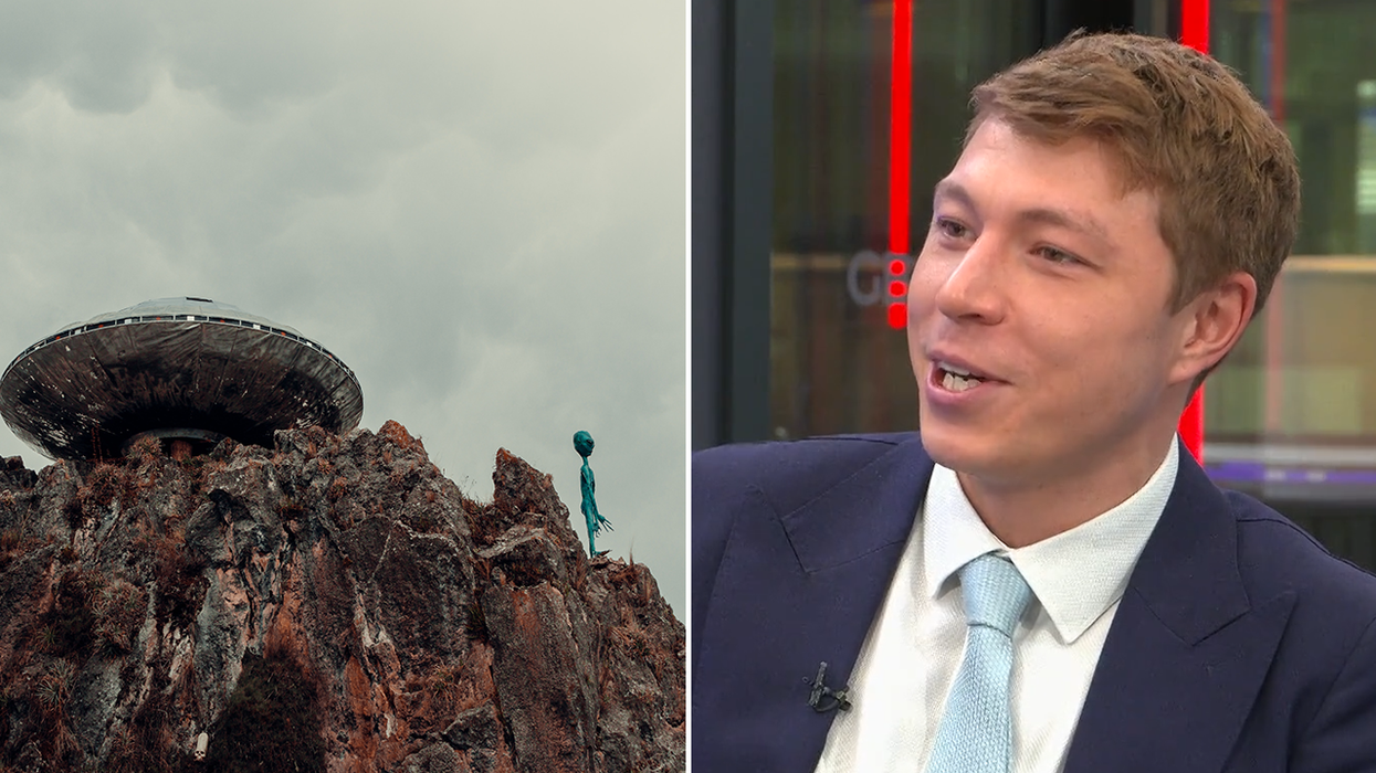 Patrick Christys and what appears to be an alien stood next to a UFO