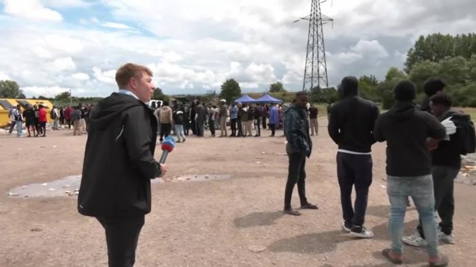 Patrick Christys attempting to speak to migrants