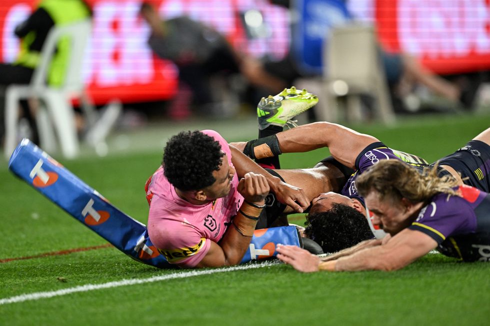 Paul Alamoti of the Penrith Panthers pictured sliding on the ground after scoring a try