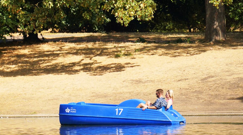 Pedalo riders traverse the Boating Lake in Regents Park, London. Britain is braced for another heatwave that will last longer than July's record-breaking hot spell, with highs of up to 35C expected next week. Picture date: Monday August 8, 2022.