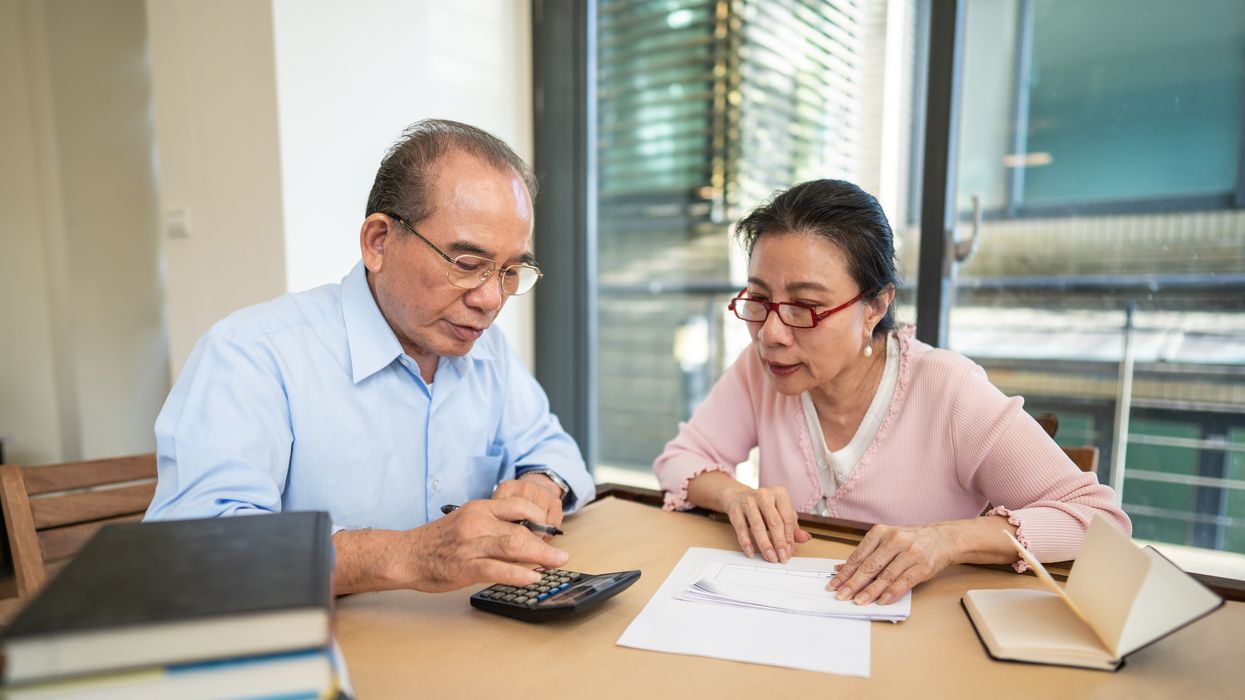 Pension savers look at calculator and documents