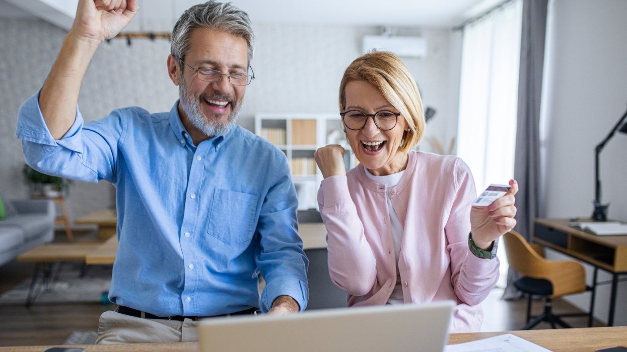 Pensioner couple happy at laptop