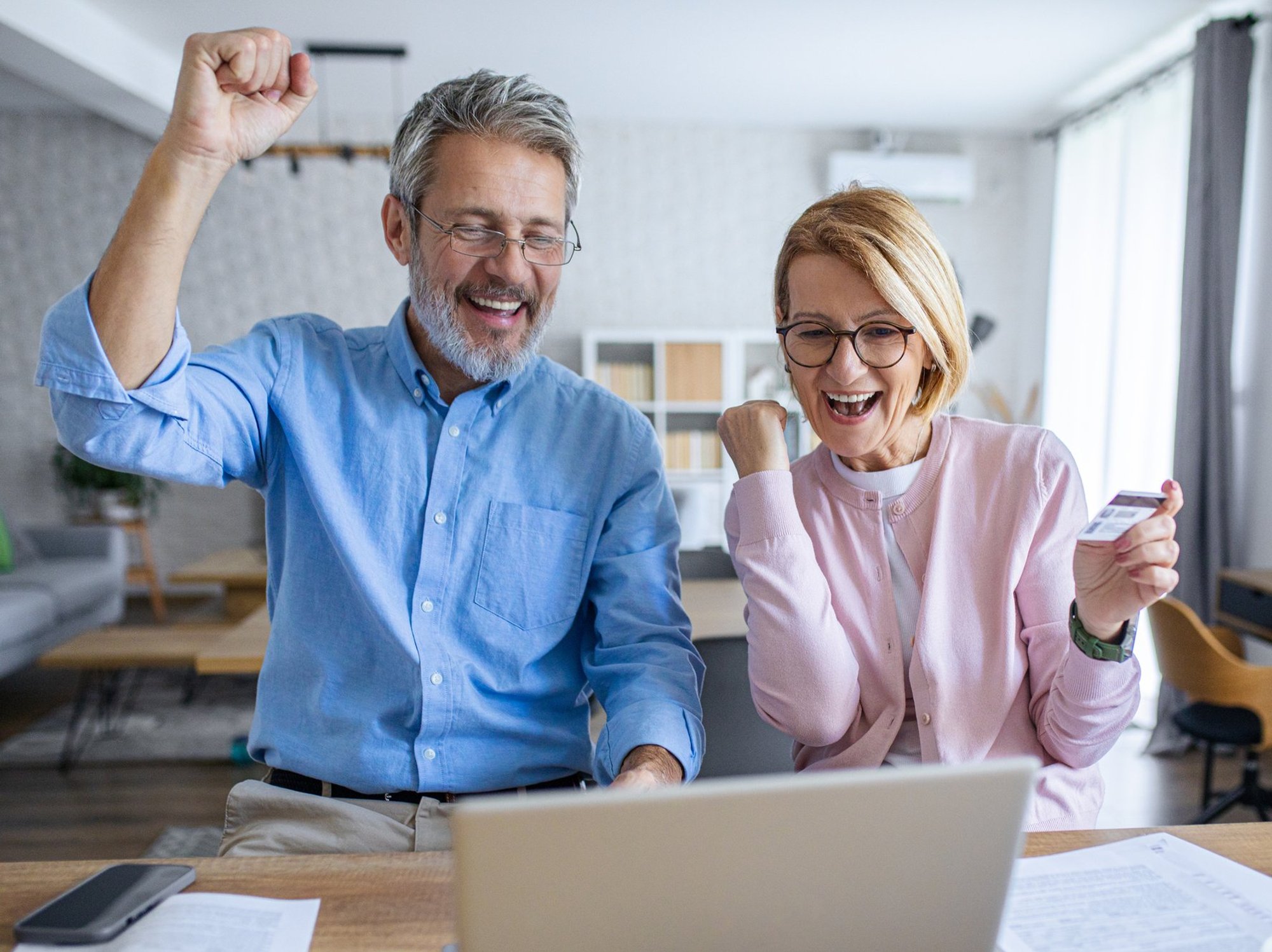 Pensioner couple happy at laptop