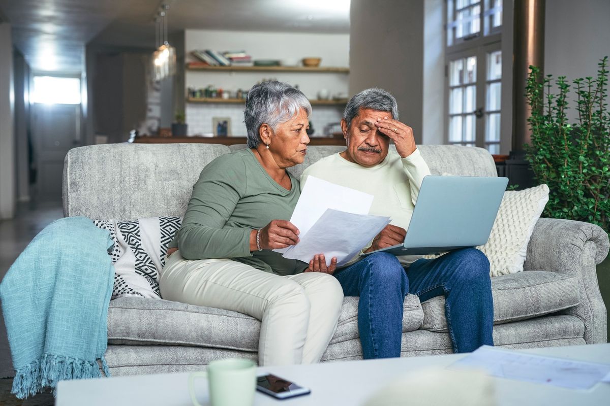 Pensioner couple looking at documents