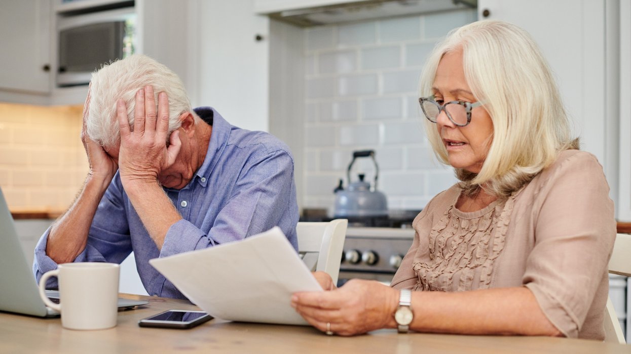 Pensioner couple worried at laptop