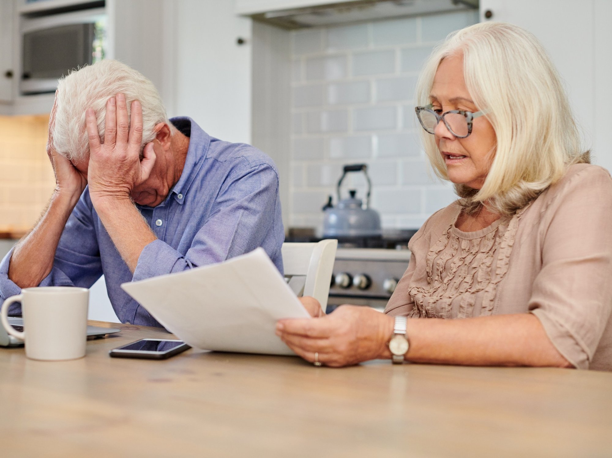 Pensioner couple worried at laptop