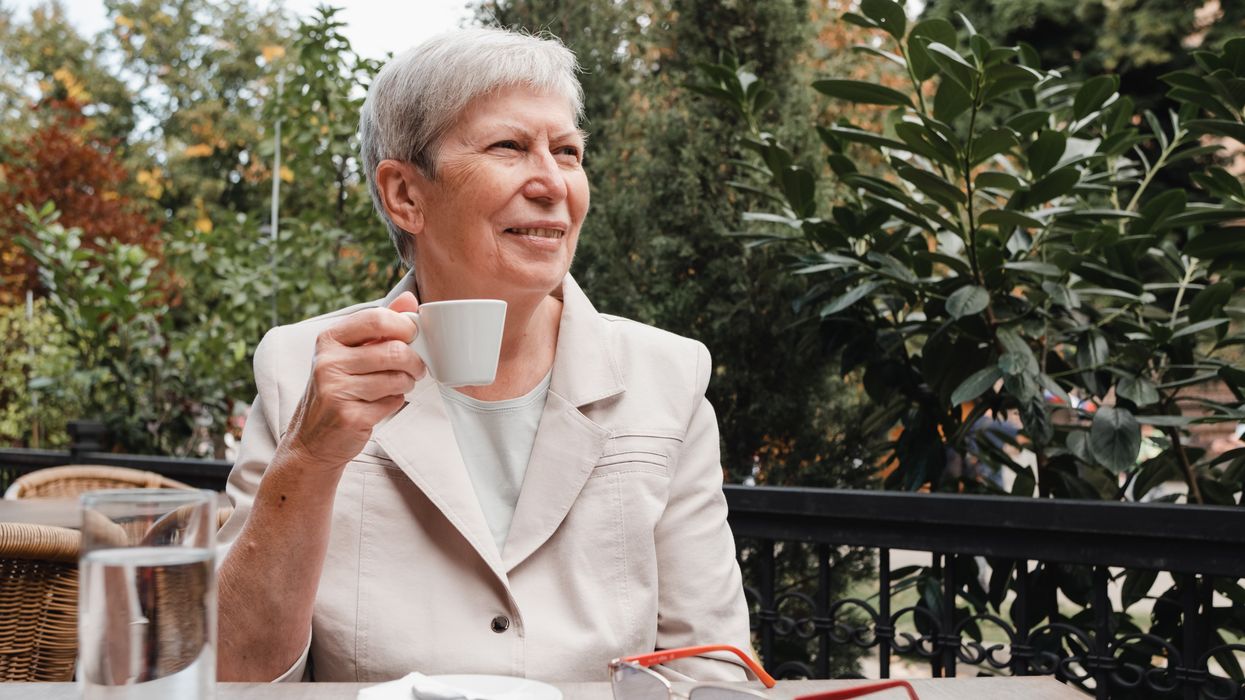 Pensioner enjoying coffee outside in retirement