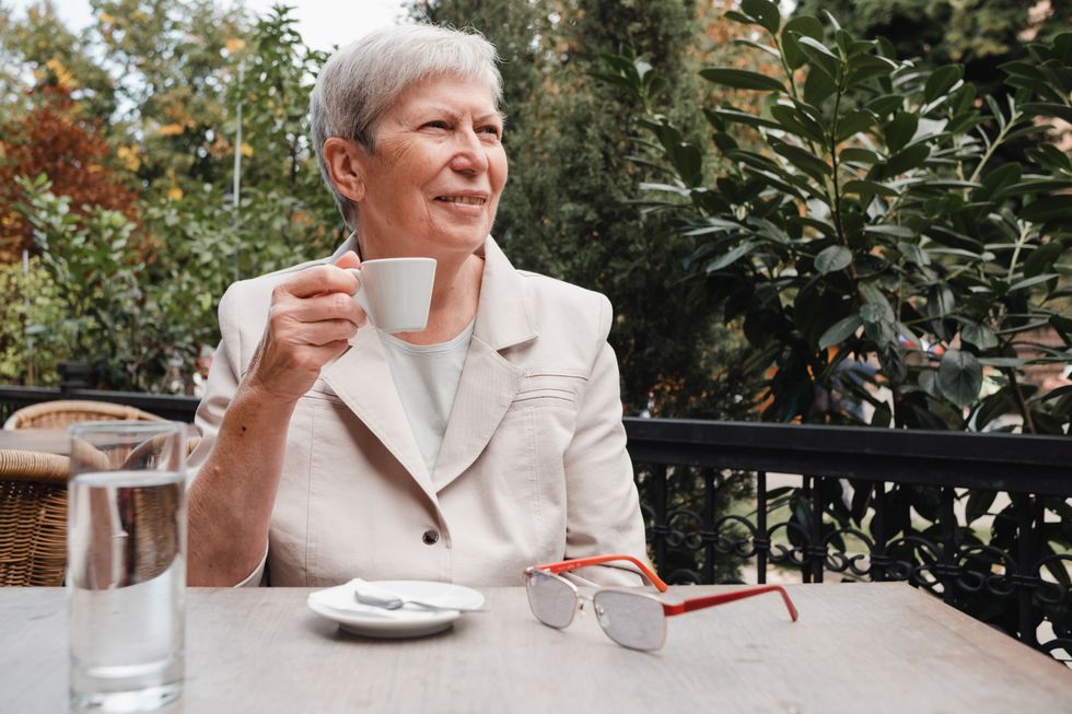 Pensioner enjoying coffee outside in retirement