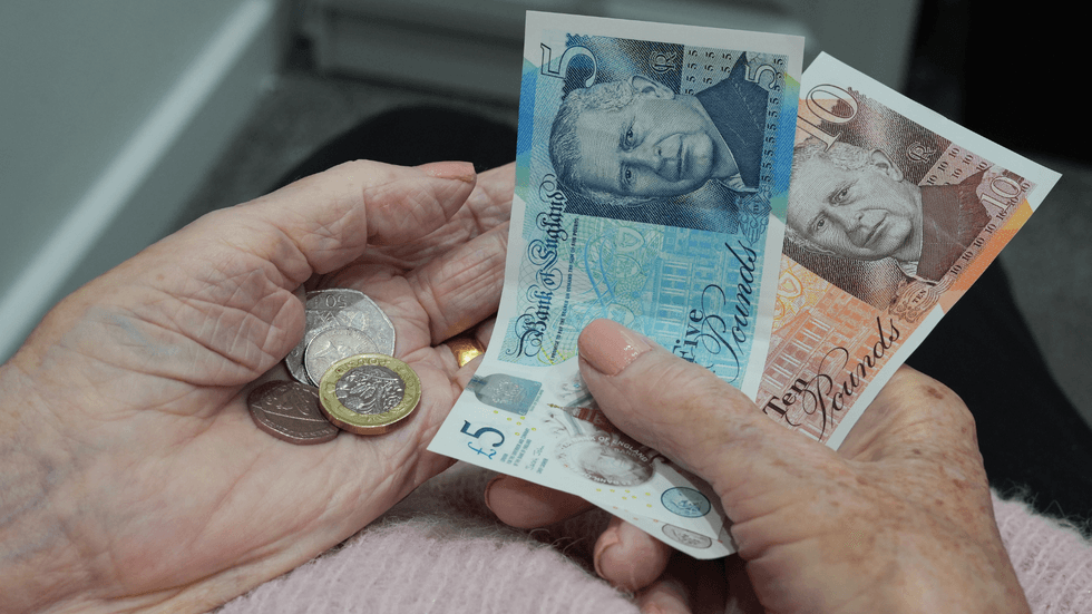 Pensioner holding cash