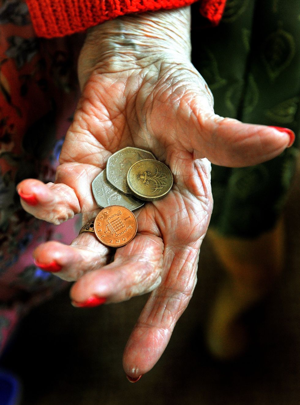 Pensioner holding coins