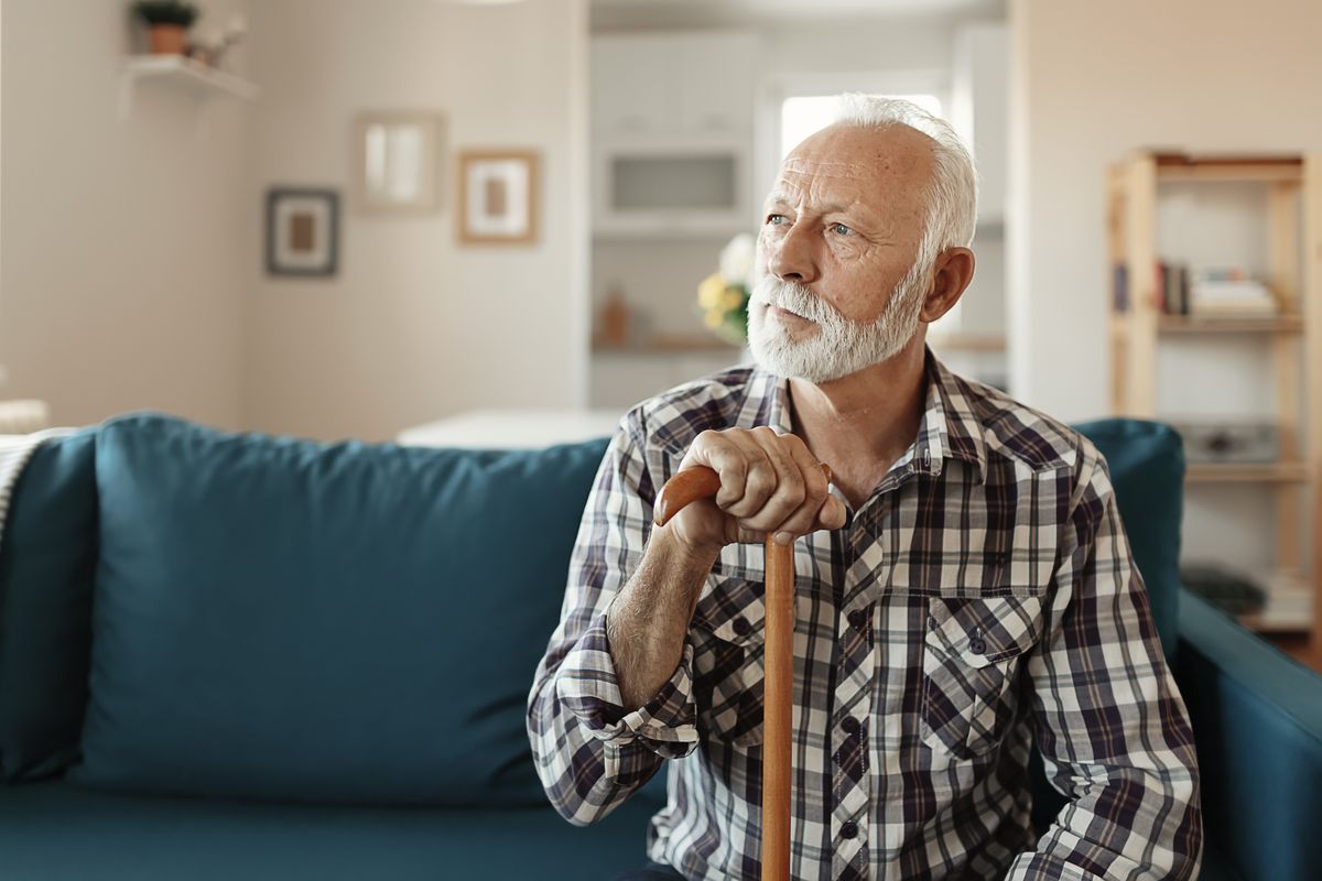 Pensioner holds walking stick in pictures