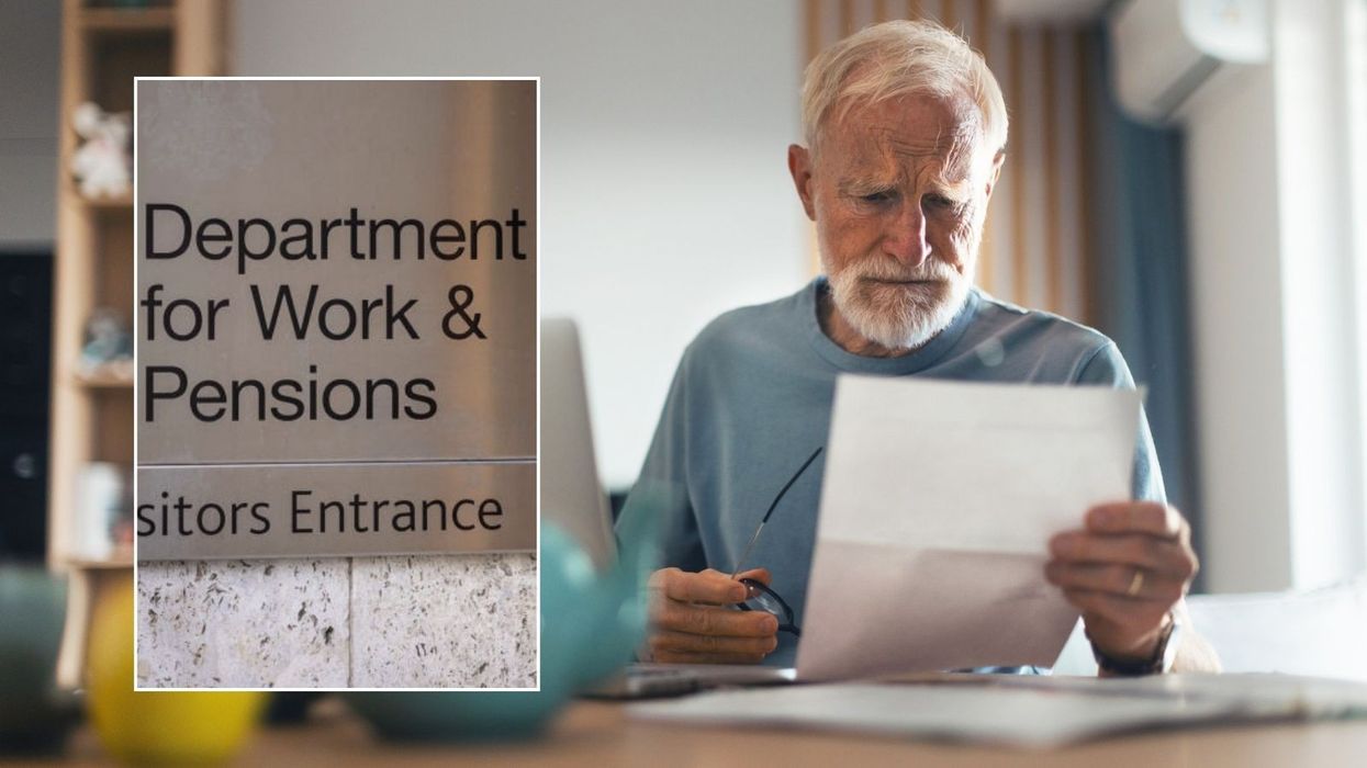 Pensioner looking at letter and DWP sign