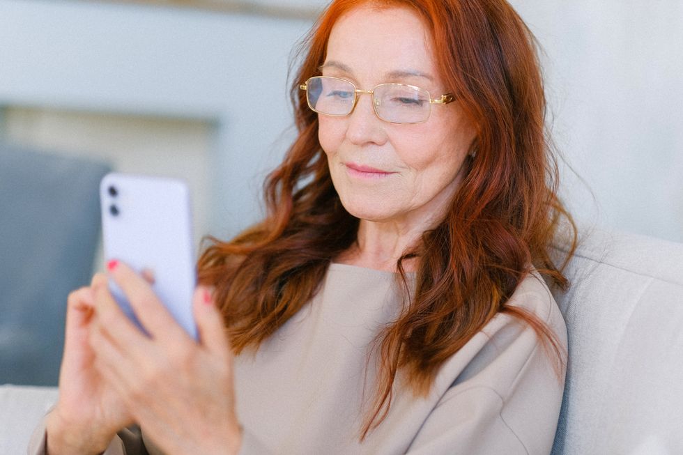 Pensioner looking at mobile phone