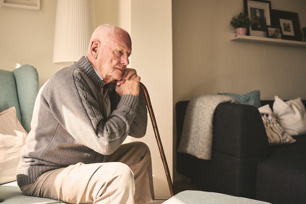 Pensioner looking worried while sitting at home