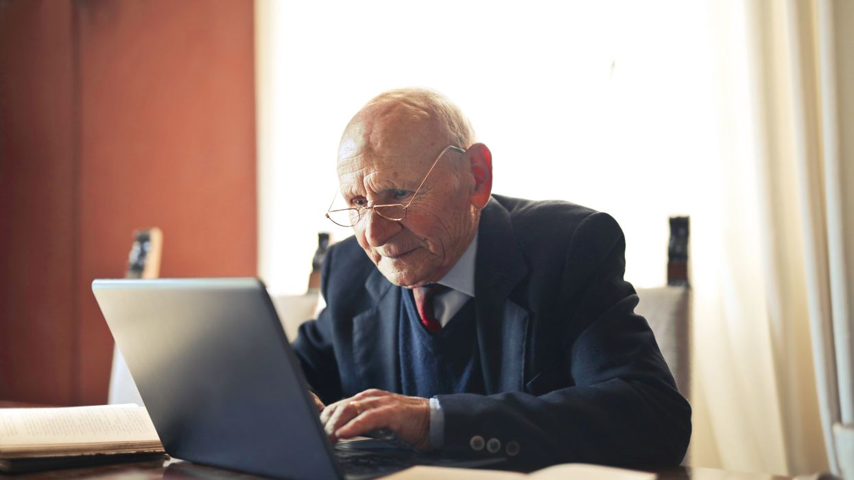 Pensioner looks at laptop